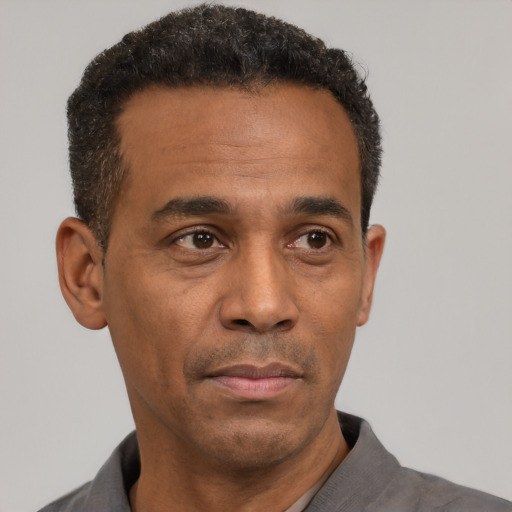 Neutral latino adult male with short  black hair and brown eyes