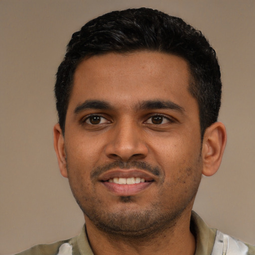 Joyful latino young-adult male with short  black hair and brown eyes