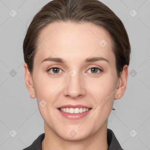 Joyful white young-adult female with short  brown hair and grey eyes