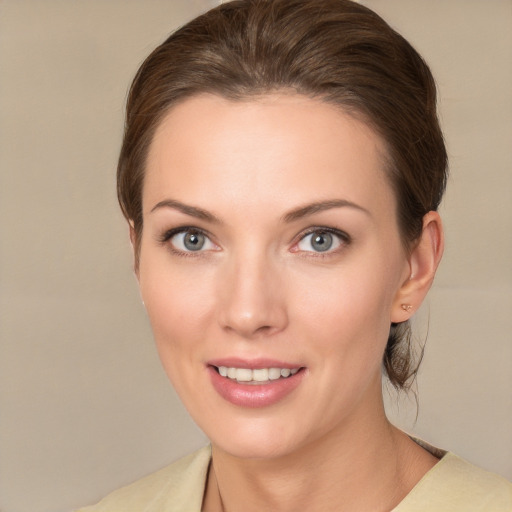 Joyful white young-adult female with medium  brown hair and grey eyes