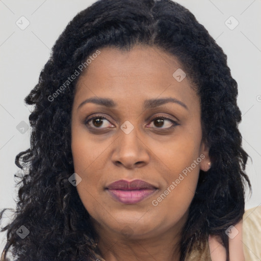 Joyful black young-adult female with long  brown hair and brown eyes