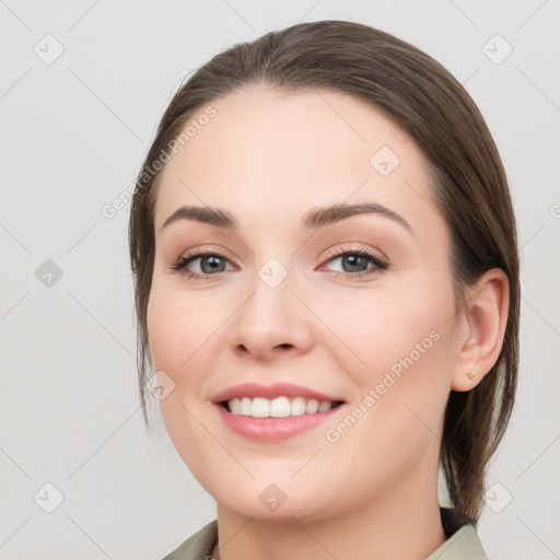 Joyful white young-adult female with medium  brown hair and grey eyes