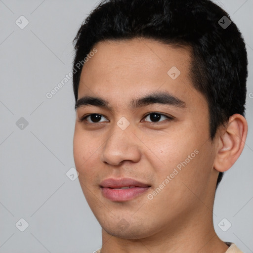 Joyful asian young-adult male with short  black hair and brown eyes