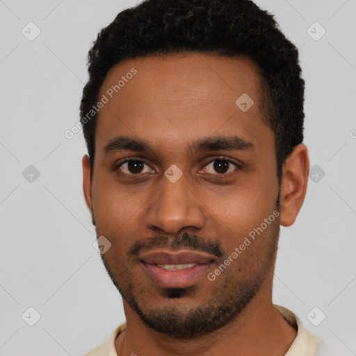 Joyful black young-adult male with short  black hair and brown eyes