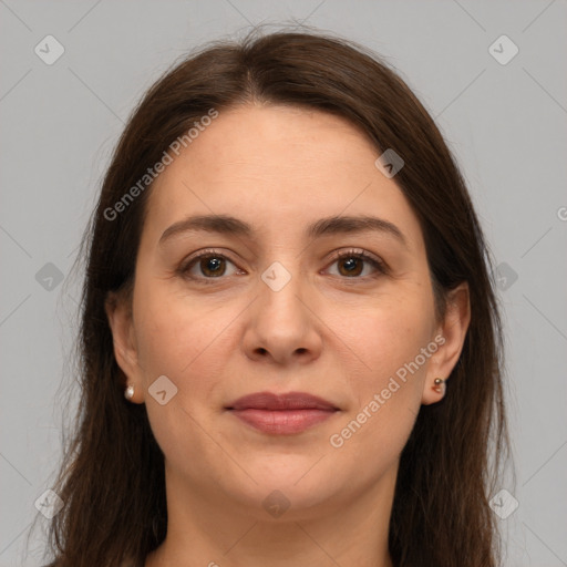 Joyful white adult female with long  brown hair and grey eyes