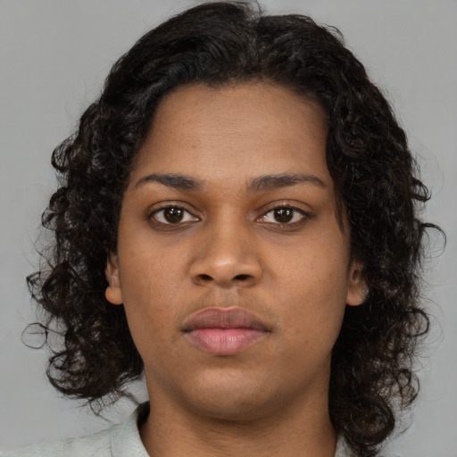 Neutral black young-adult female with medium  brown hair and brown eyes