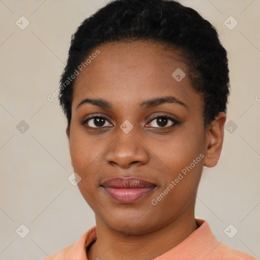 Joyful black young-adult female with short  black hair and brown eyes