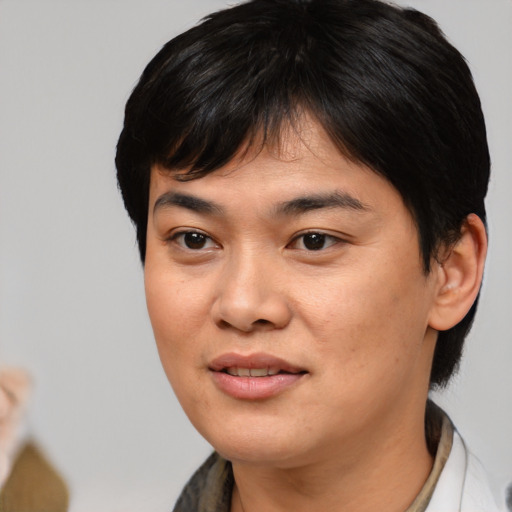 Joyful asian young-adult female with medium  brown hair and brown eyes