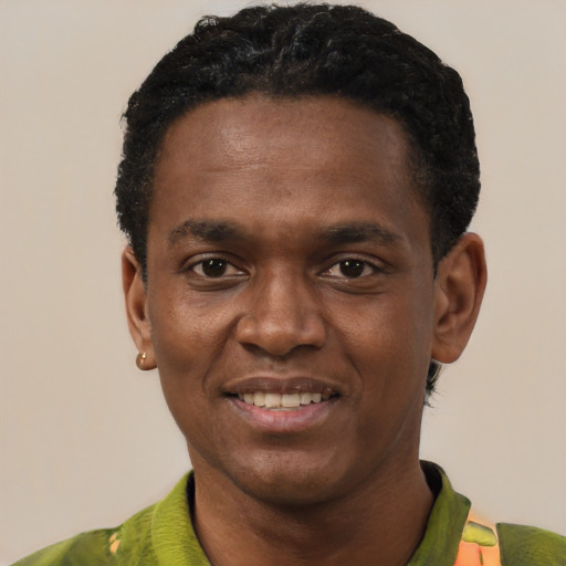 Joyful black young-adult male with short  black hair and brown eyes