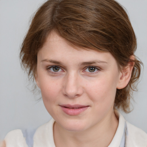 Joyful white young-adult female with medium  brown hair and blue eyes