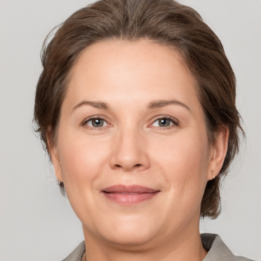 Joyful white adult female with medium  brown hair and brown eyes