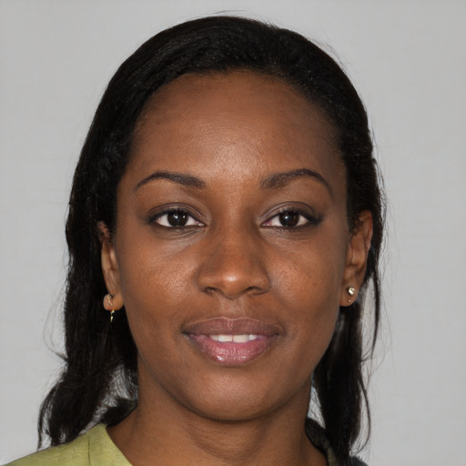 Joyful black young-adult female with long  brown hair and brown eyes
