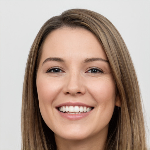 Joyful white young-adult female with long  brown hair and brown eyes