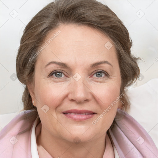 Joyful white adult female with medium  brown hair and grey eyes