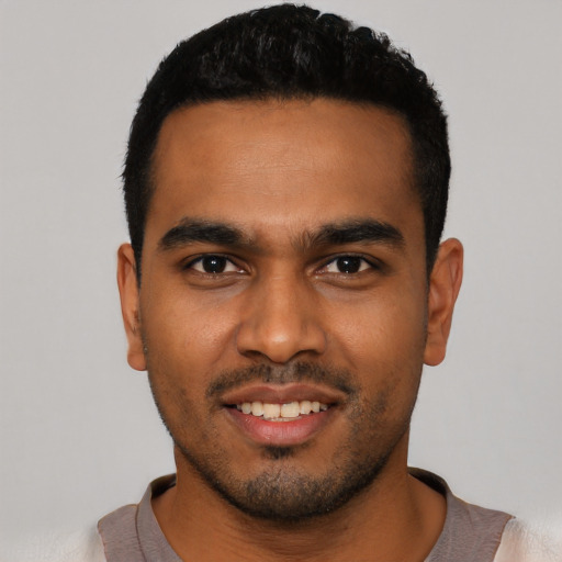 Joyful latino young-adult male with short  black hair and brown eyes