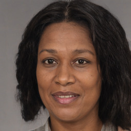 Joyful black adult female with medium  brown hair and brown eyes