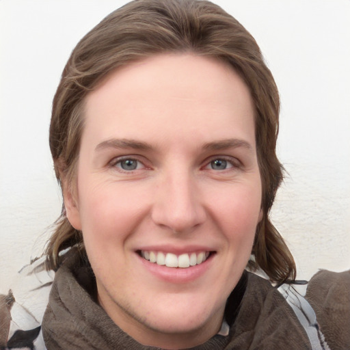 Joyful white young-adult female with medium  brown hair and grey eyes