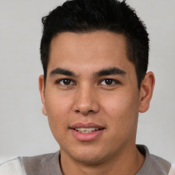 Joyful latino young-adult male with short  brown hair and brown eyes