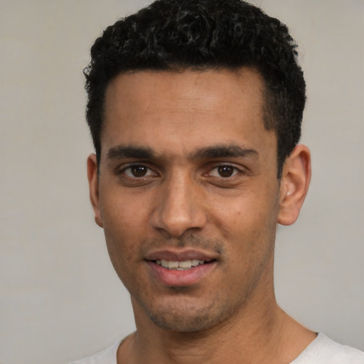 Joyful white young-adult male with short  black hair and brown eyes