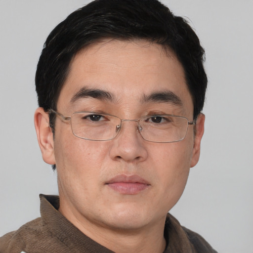 Neutral asian young-adult male with short  brown hair and brown eyes