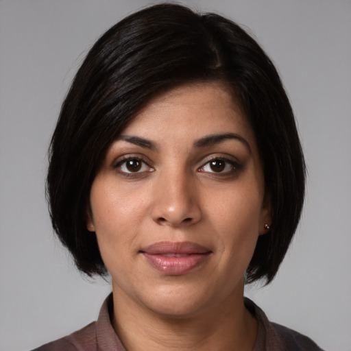 Joyful white young-adult female with medium  black hair and brown eyes