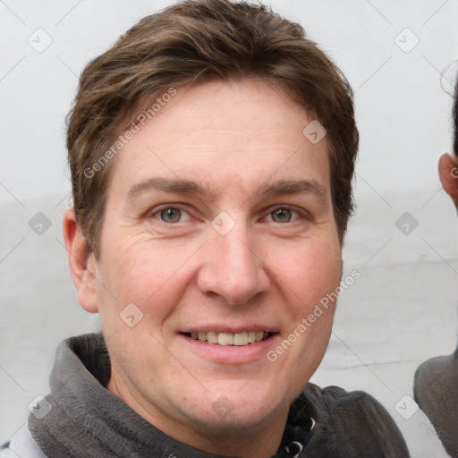 Joyful white adult male with short  brown hair and grey eyes