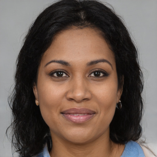 Joyful black young-adult female with medium  brown hair and brown eyes