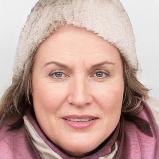 Joyful white adult female with medium  brown hair and blue eyes