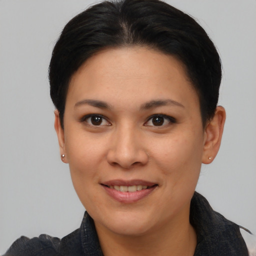 Joyful asian young-adult female with short  black hair and brown eyes