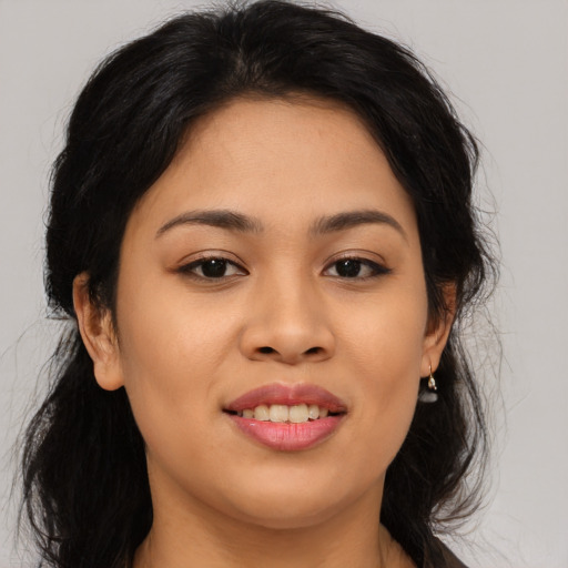Joyful asian young-adult female with long  black hair and brown eyes