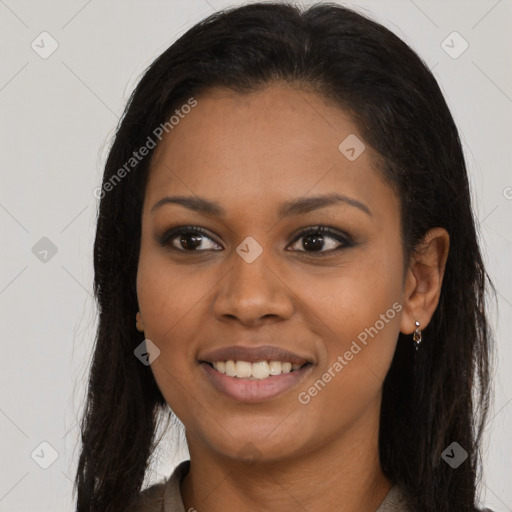 Joyful black young-adult female with long  brown hair and brown eyes