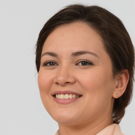 Joyful white young-adult female with medium  brown hair and brown eyes