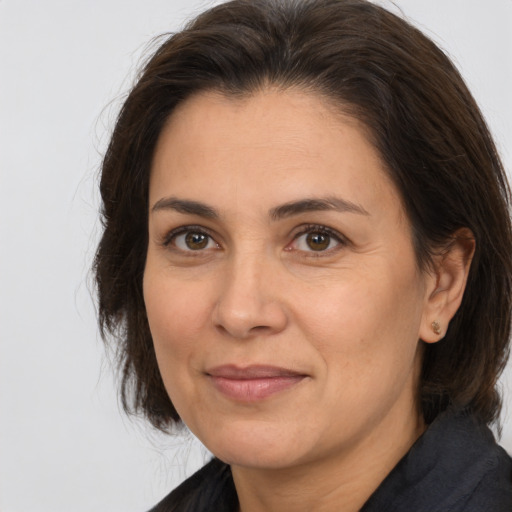 Joyful white adult female with medium  brown hair and brown eyes
