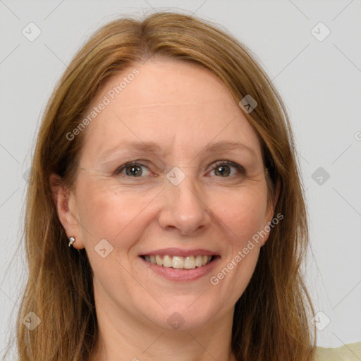 Joyful white adult female with long  brown hair and grey eyes