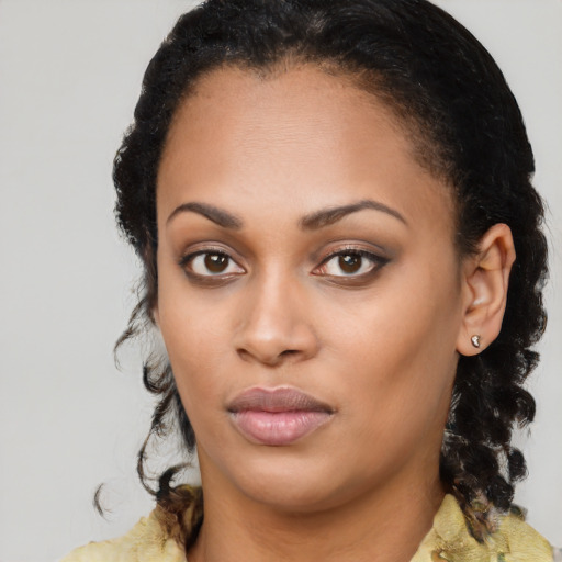 Joyful black young-adult female with medium  black hair and brown eyes