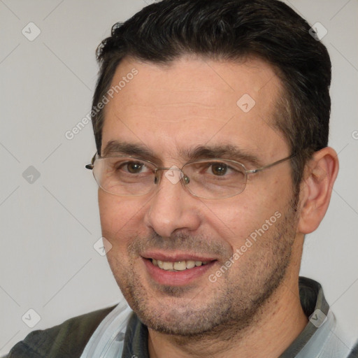 Joyful white adult male with short  brown hair and brown eyes