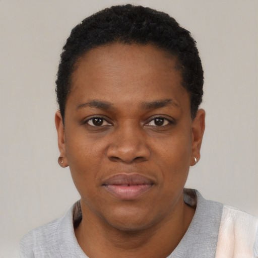 Joyful black adult female with short  black hair and brown eyes
