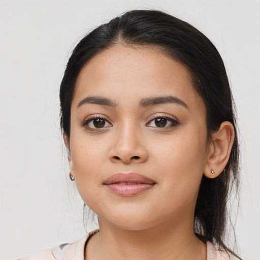 Joyful latino young-adult female with medium  black hair and brown eyes