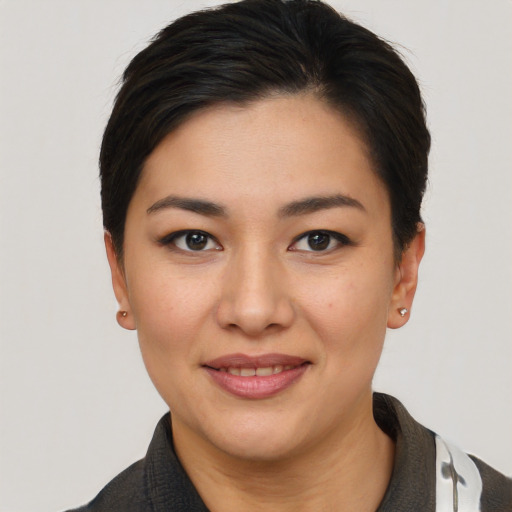 Joyful asian young-adult female with short  black hair and brown eyes