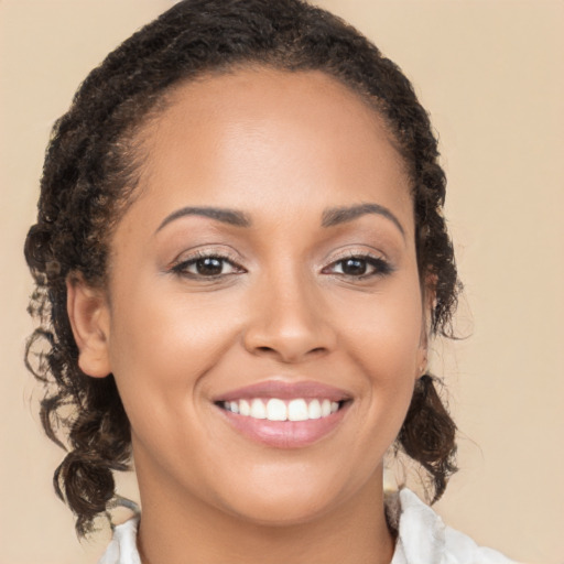 Joyful latino young-adult female with medium  brown hair and brown eyes