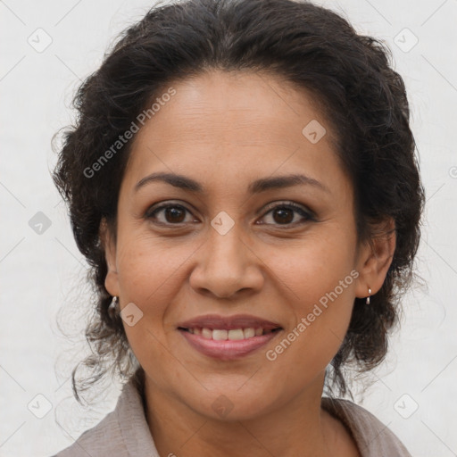 Joyful latino adult female with medium  brown hair and brown eyes