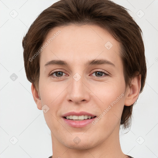 Joyful white young-adult female with short  brown hair and grey eyes