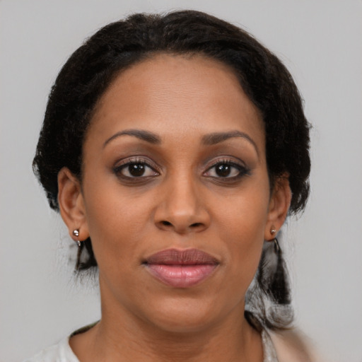 Joyful black young-adult female with medium  brown hair and brown eyes