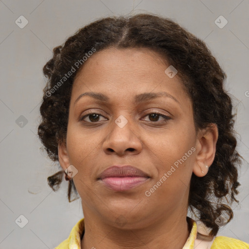 Joyful black adult female with medium  brown hair and brown eyes