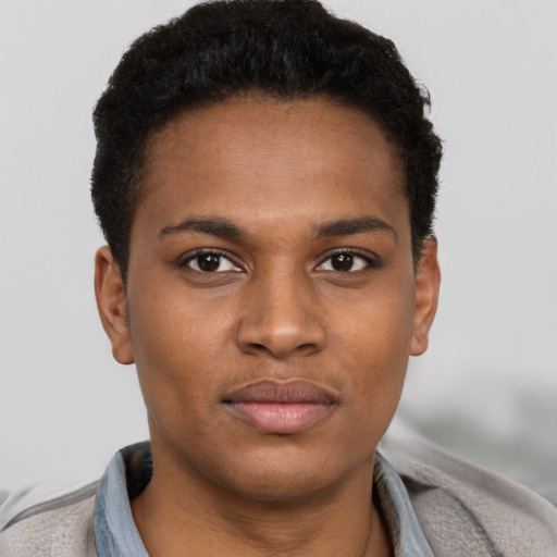 Joyful black young-adult male with short  brown hair and brown eyes