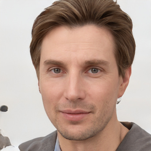 Joyful white adult male with short  brown hair and grey eyes