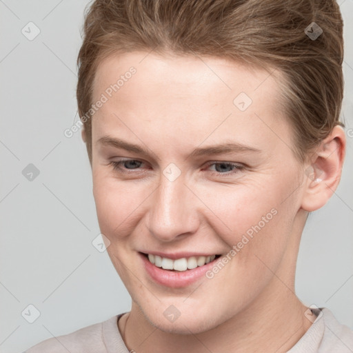 Joyful white young-adult female with short  brown hair and grey eyes