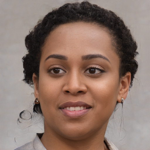 Joyful black young-adult female with medium  brown hair and brown eyes