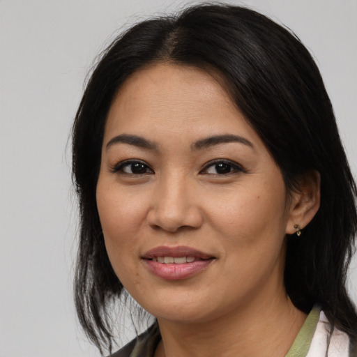 Joyful asian young-adult female with medium  black hair and brown eyes