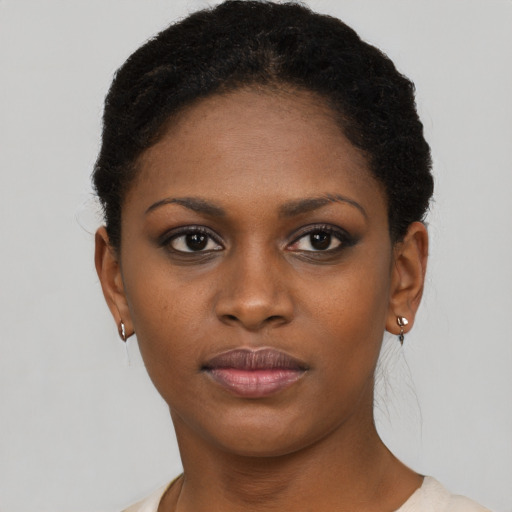 Joyful black young-adult female with short  brown hair and brown eyes